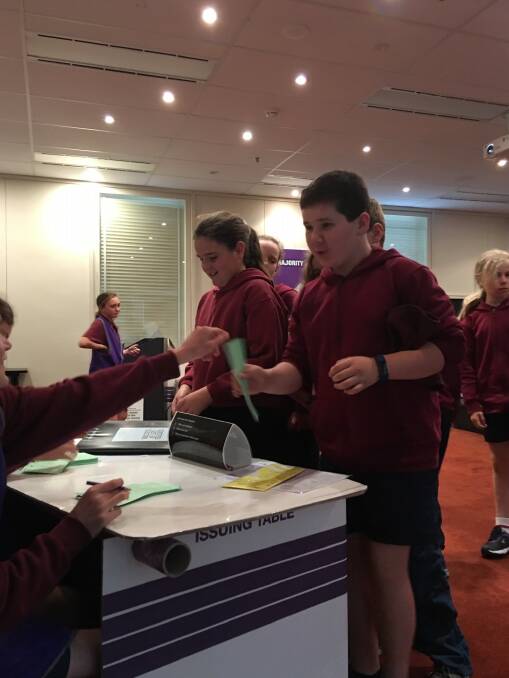 VOTE CASTING: Bombala Public School students Jack Tellis and Lily Hampshire casting their vote in a mock-election during a visit to the Australian Electoral Commission.