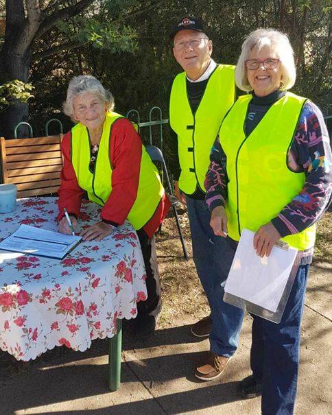 Maureen Peisley with Roger and Bev Moulds signing the Save Bombala demerge petition on Election Day.
