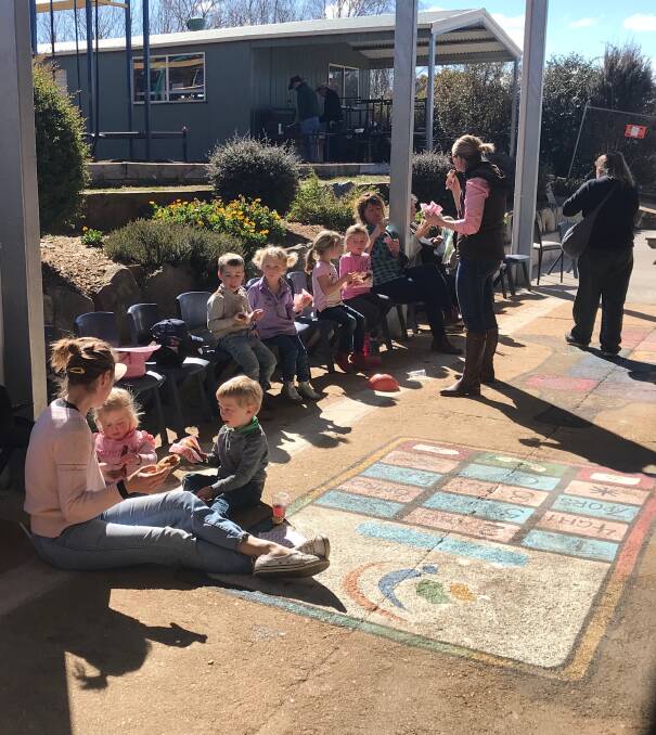 St. Joseph's Primary School (SPICE) Supported Playgroups In Catholic Education infants enjoying a sausage sizzle at the school Fiver for a Farmer fundraiser.