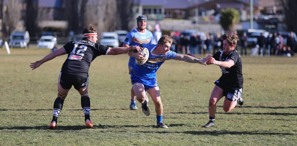 Bombala's Blake Robinson fends off some Cooma players during Sunday's Group 16 semi final at Cooma.