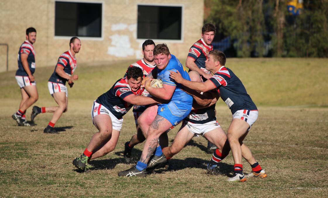 FINALS: The Bega Roosters tackle Bombala Blue Heeler Adam Rodwell in Sunday's qualifying game where the Heelers were defeated 22 to 18 in a tough and exciting game.