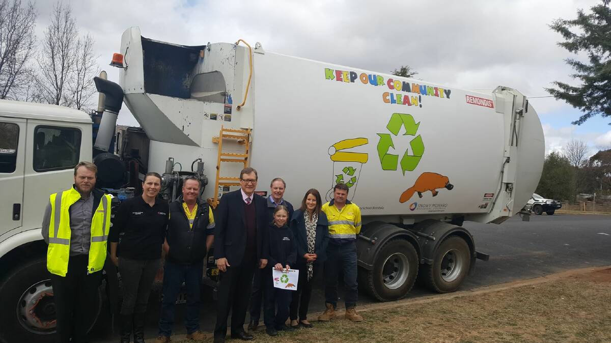 ALEX'S ART: Alex Reed with Snowy Monaro Regional mayor John Rooney, council staff and her winning design on the council garbage truck