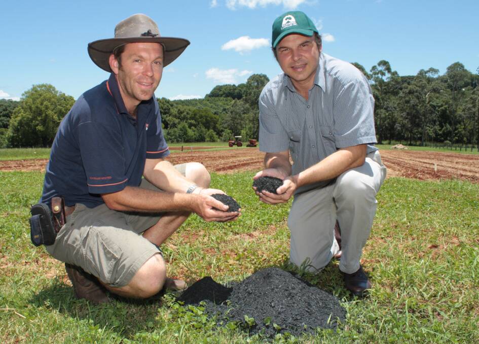 NSW Department of Primary Industries technical officer, Josh Rust and research scientist, Dr Lukas Van Zwieten inspect a biochar soil amendment trial at the DPI Wollongbar Primary Industries Institute.