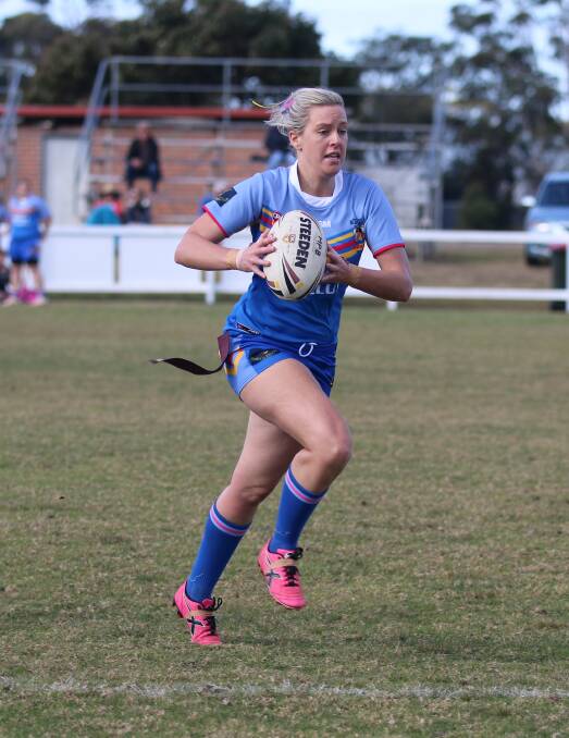 OFF: Bombala High Heeler Kristy Nichols runs with the ball during the high-powered ladies league tag game against Pambula Merimbula Hot Doggies on Sunday.