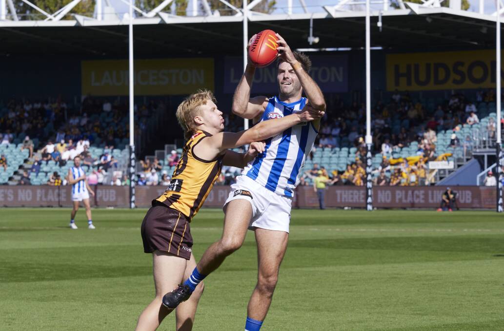 Hawthorn's Cam Mackenzie and North Melbourne's Luke McDonald. Picture by Rod Thompson 