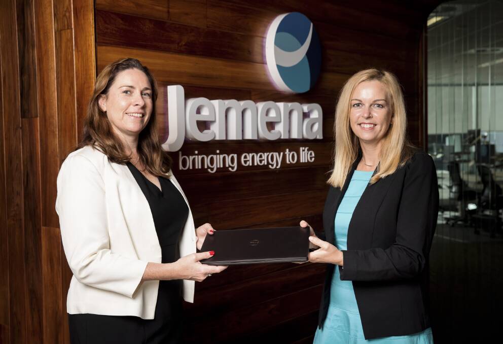 Jemena General Manager, Gabrielle Sycamore donates the first of one hundred laptops to Campbell Page CEO Natalie Turmine. Photo supplied.