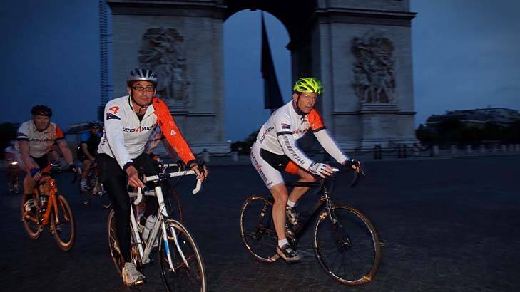 Wheel deal: Tony Abbott cycles past the Arc de Triomphe in support of an Australian ex-services charity. Photo: Andrew Meares