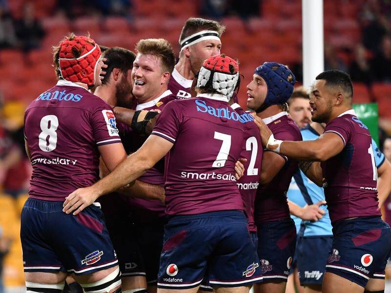 The Reds have beaten the Waratahs 32-26 in a tight Super Rugby AU opener in Brisbane.