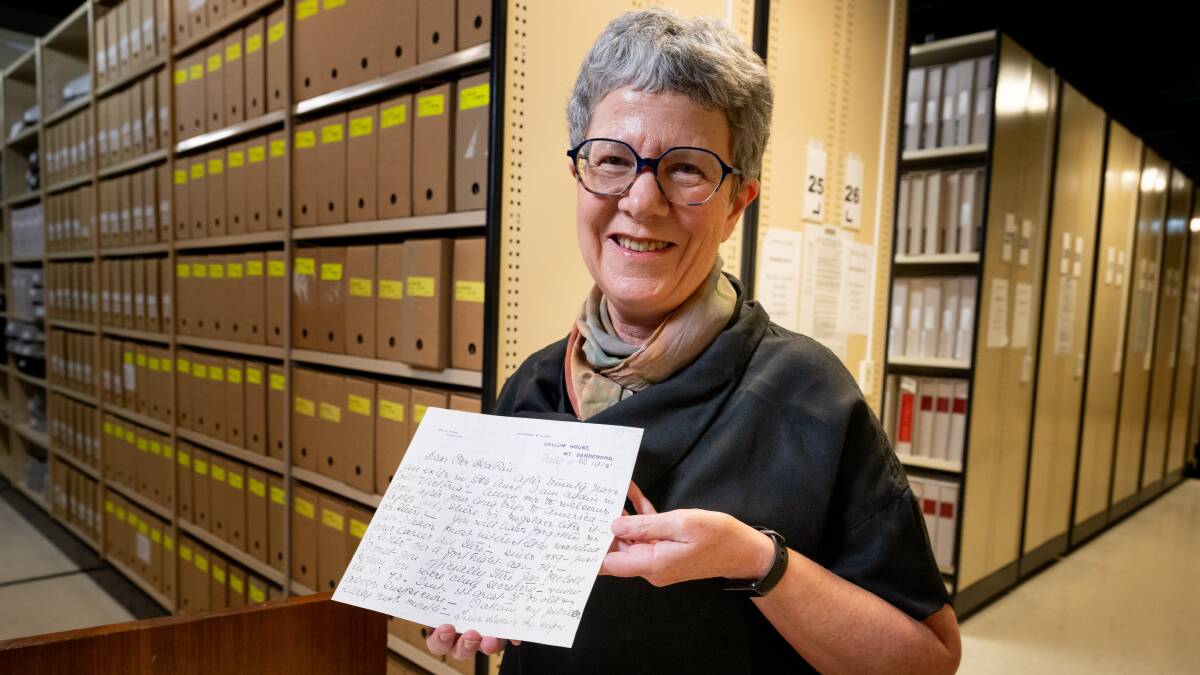National Library of Australia director-general Marie-Louise Ayres with one of the millions of handwritten manuscripts. Picture by Elesa Kurtz