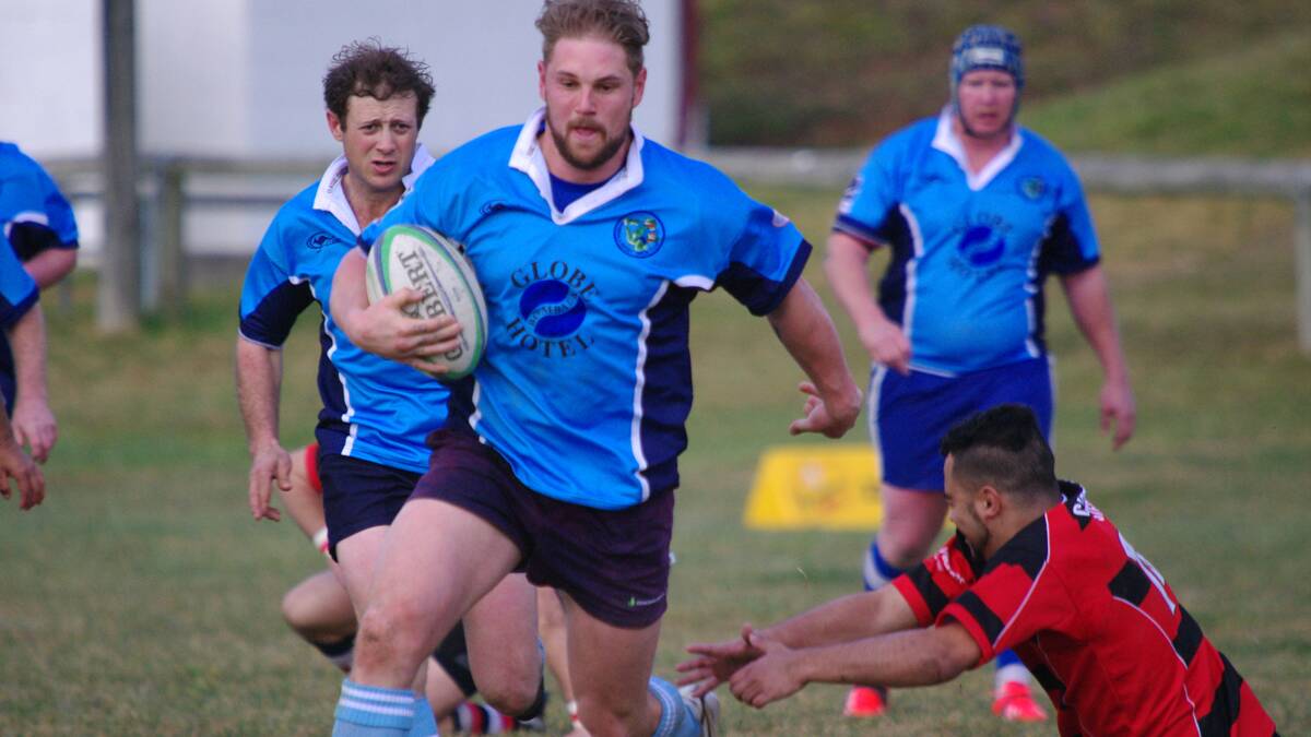 Leigh Hodak for the Bombala Bluetongues escapes the desperate reach of a Batemans Bay Boars player.