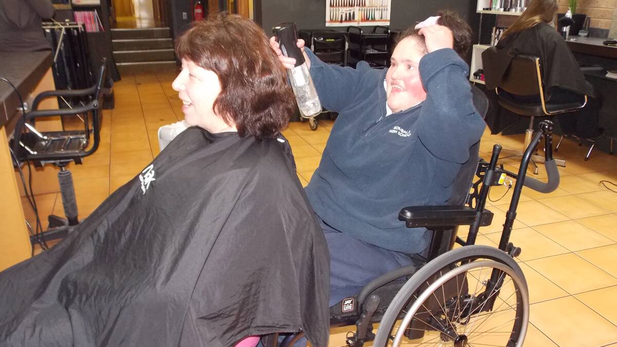 Ellie Hodak at work at Hair On Main with Bombala High School learning support officer Connie Cotterill.