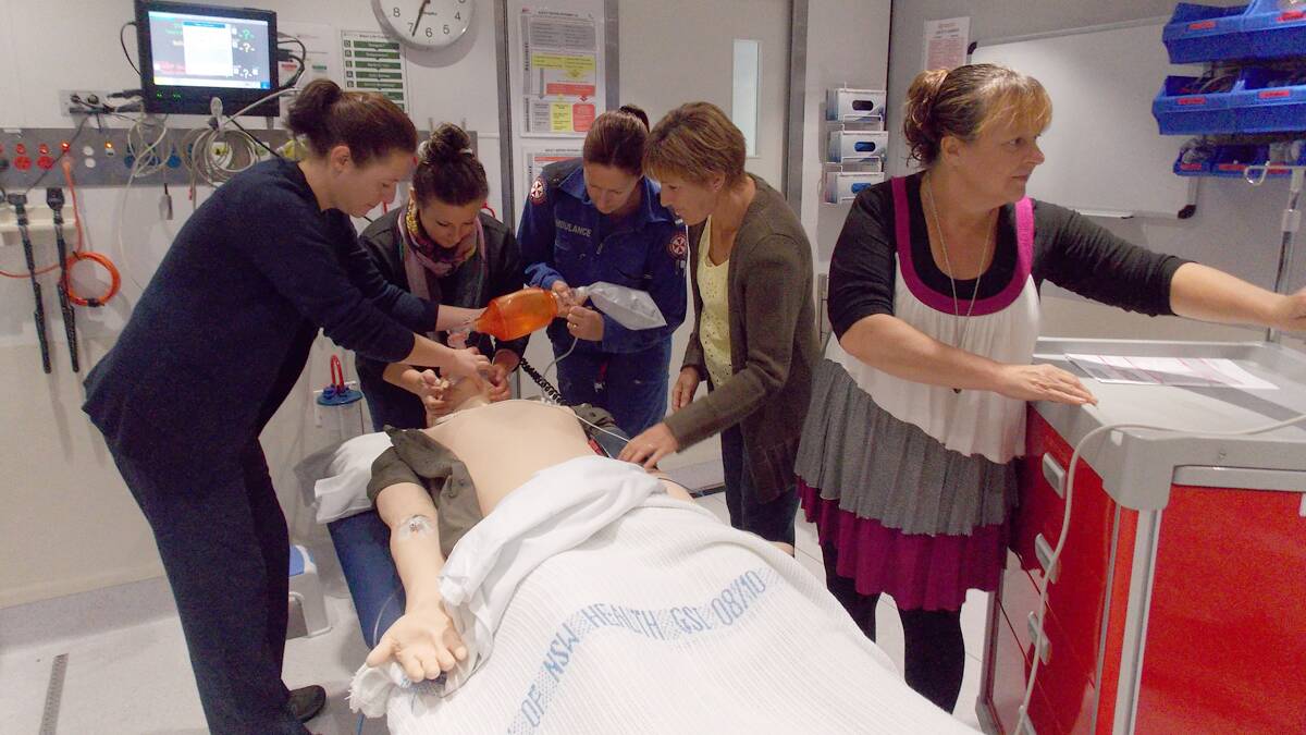 Bombala medical staff, from left; Rosie Gillespie-Jones, Julie Mann, Jane Dunn, Helen Stone and Linda Holster practise on their patient “George” on the Sister Alison Bush Mobile Simulation Centre.