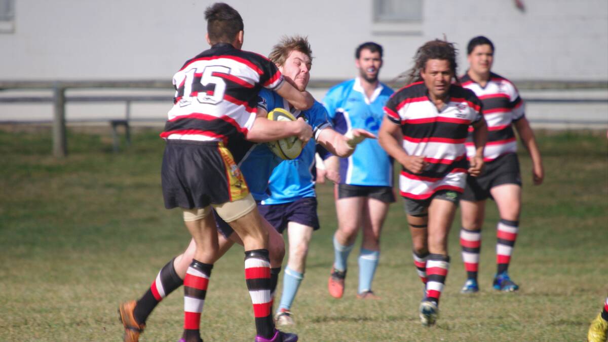 Jackson Standen for the Bombala Bluetongues runs into a spot of bother from a Boars player.