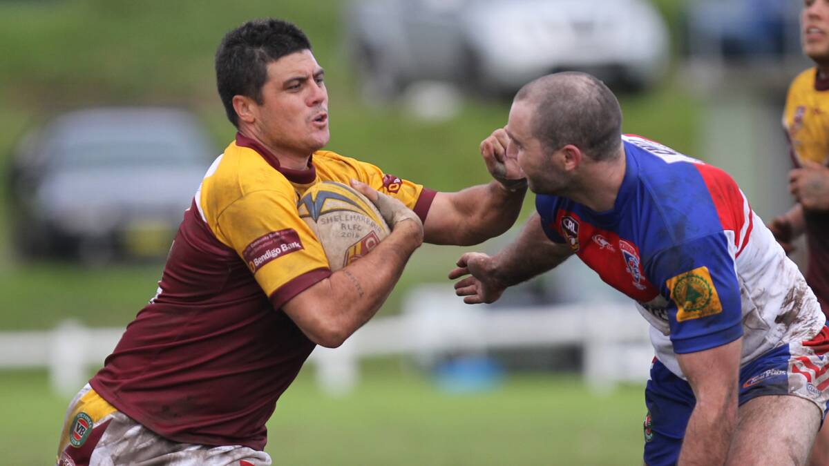 LAKE TIMES: Shellharbour centre Bronx Goodwin tries to fend off his opposite number Peter Cronin during Sunday’s muddy battle at Shellharbour. Picture: DAVID HALL