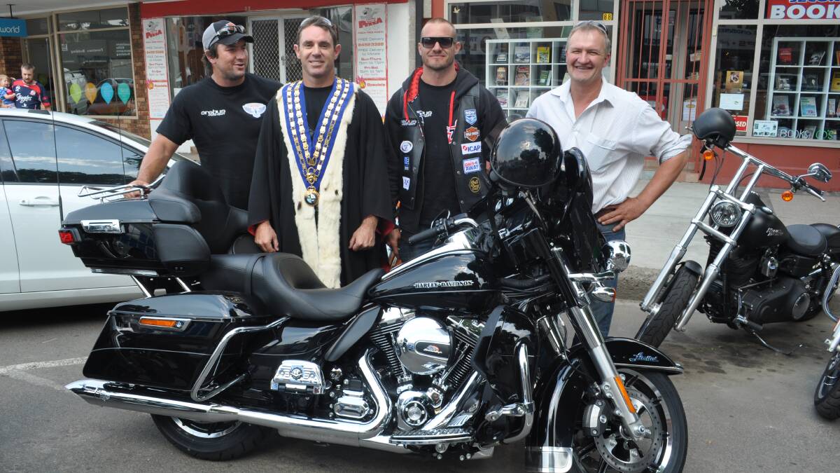 COOMA :Rugby League legends Nathan Hindmarsh, Brad Fittler and Matt Cooper came to Cooma as part of the Hogs for Homeless Charity Ride raising money for Father Chris Riley’s Youth of the Streets. As part of the fun Brad Fittler donned Dean Lynch’s mayoral robes.