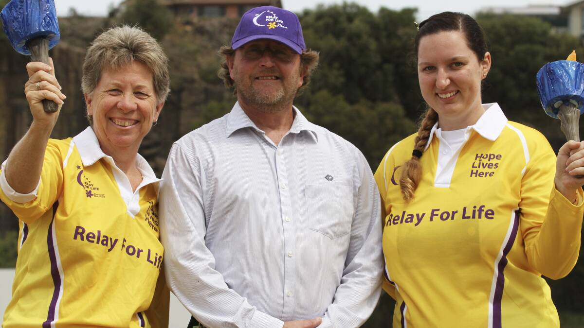 KIAMA: Kiama Relay for Life committee members Marie Dalton, Michael Innes and Hannah Hutchinson with models of the Olympic Touch. Picture: DAVID HALL 