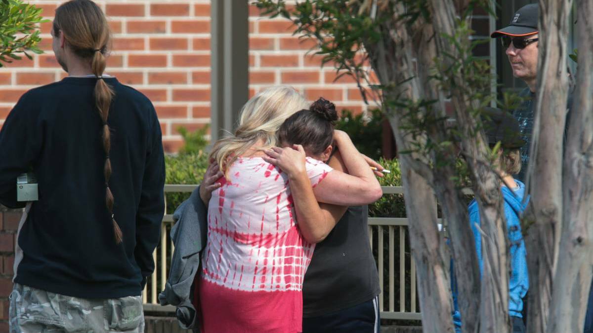 A woman is comforted at the scene of Thursday night’s double shooting in Towradgi. Picture: Adam McLean 