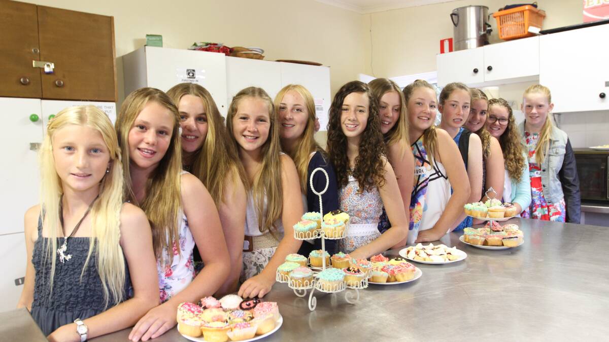ULLADULLA: Teen Showgirl entrants Ellyn Cornock, Tina Taylor, Amy Burgess, Abbey Montgomery, Brittany Walker, Chloe Dadd, Sky Hession, Laura McLaren, Brittany Anderson, Eleanor Drury and Ruby Jones are joined by last year’s winner Abby Wilesmith (second from right) in the kitchen at the Milton Masonic Hall baking cupcakes and scones on the weekend. 