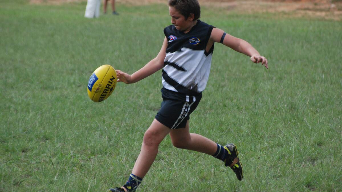  MOGO: Mogo Magic under 16s player Christopher Innocenti gets a kick away against the Bomaderry Tigers on Sunday.  