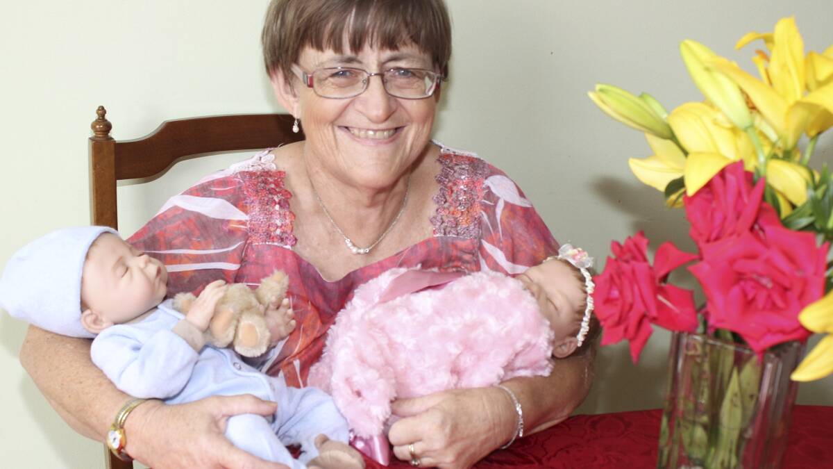 KIAMA: Albion Park Rail's Annette Holmes with two of her replacement 'babies' at home last week. She has been recognised for her tremendous work as a foster mother. Picture: DAVID HALL  
