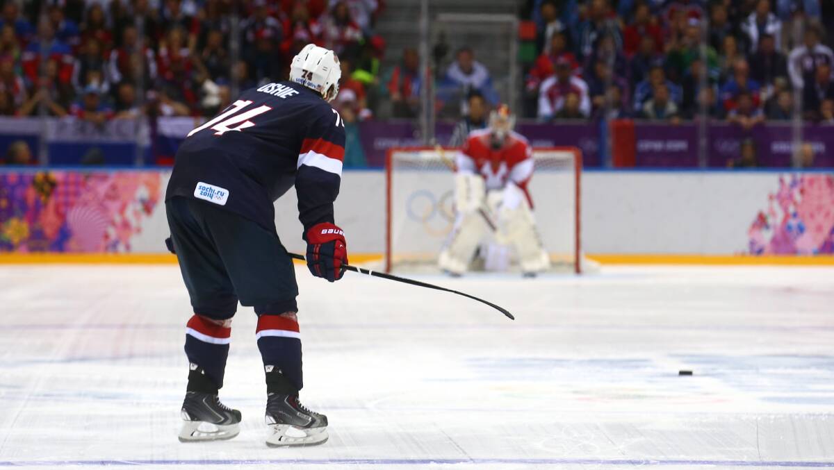  T.J. Oshie #74 of the United States scores on a shootout against Sergei Bobrovski #72 of Russia during the Men's Ice Hockey Preliminary Round Group A game on day eight of the Sochi 2014 Winter Olympics. Photo by Streeter Lecka/Getty Images