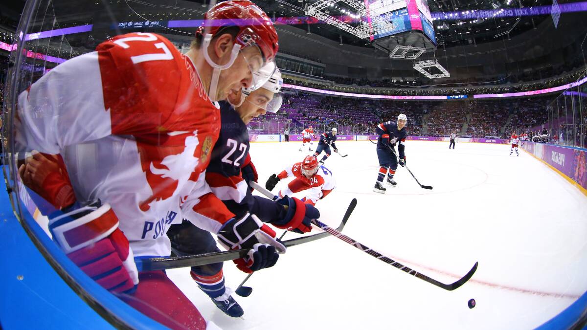  Kevin Shattenkirk #22 of United States handles the puck against Alexei Tereshchenko #27 of Russia in the first period during the Men's Ice Hockey Preliminary Round Group A game on day eight of the Sochi 2014 Winter Olympics at Bolshoy Ice Dome. Photo by Al Bello/Getty Images