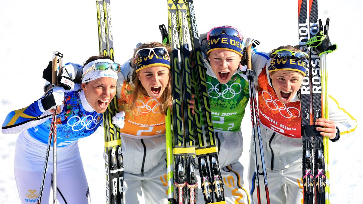 Charlotte Kalla, Anna Haag, Emma Wiken and Ida Ingemarsdotter of Sweden celebrate winning the gold medal in the Women's 4 x 5 km Relay during day eight of the Sochi 2014 Winter Olympics at Laura Cross-country Ski & Biathlon Center.  Photo by Richard Heathcote/Getty Images
