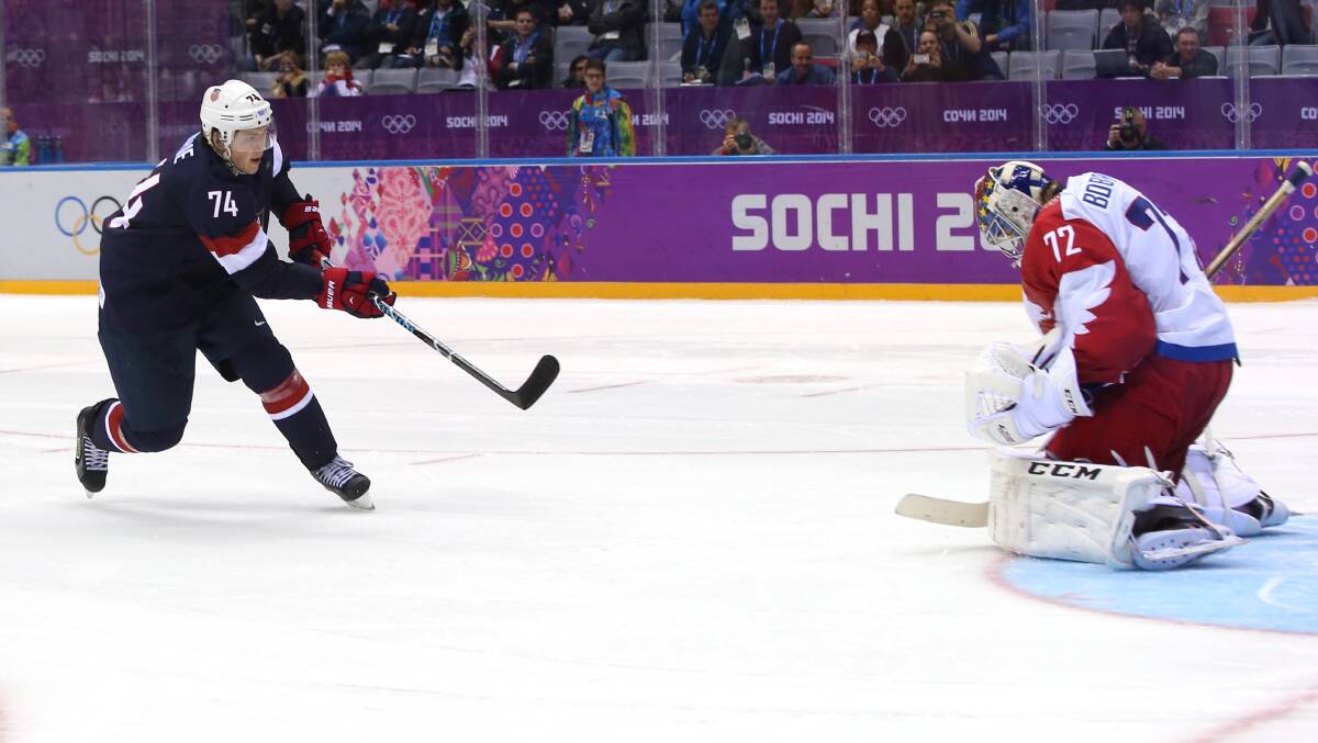 T.J. Oshie #74 of the United States scores on a shootout against Sergei Bobrovski #72 of Russia to win the Men's Ice Hockey Preliminary Round Group A game on day eight of the Sochi 2014 Winter Olympics.  Photo by Bruce Bennett/Getty Images