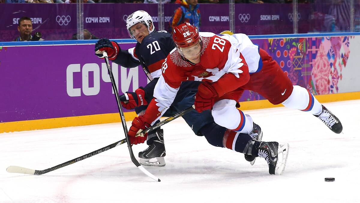  Ryan Suter #20 of the United States and Alexander Syomin #28 of Russia fight for the puck during the Men's Ice Hockey Preliminary Round Group A game on day eight of the Sochi 2014 Winter Olympics. Photo by Streeter Lecka/Getty Images