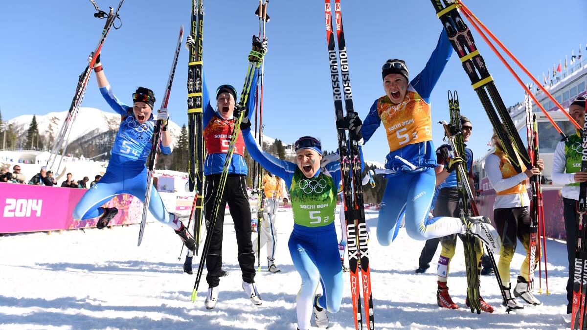 Silver medalists Krista Lahteenmaki, Anne Kylloenen, Aino-Kaisa Saarinen and Kerttu Niskanen of Finland celebrate after the Women's 4 x 5 km Relay during day eight of the Sochi 2014 Winter Olympics. Photo by Harry How/Getty Images