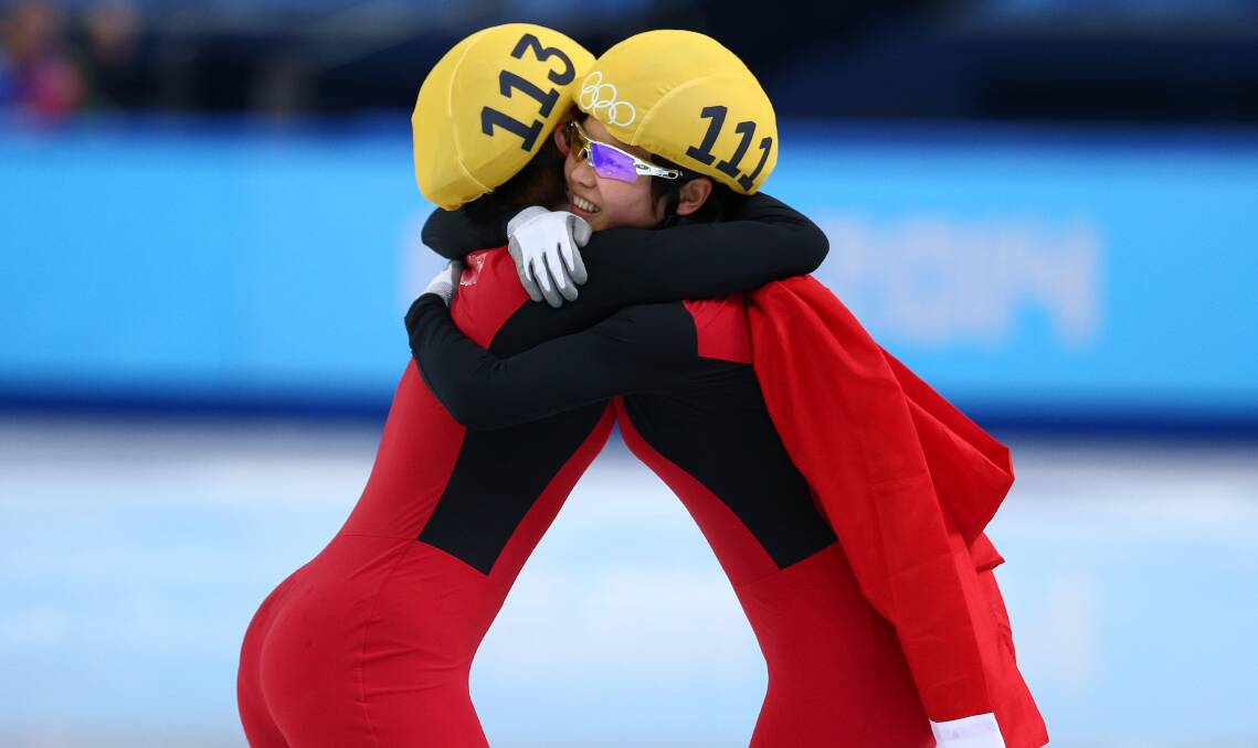  Yang Zhou (L) of China is congratulated by Jianrou Li of China after winning the gold medal during the Ladies' 1500 m Final Short Track Speed Skating on day 8 of the Sochi 2014 Winter Olympics. Photo by Paul Gilham/Getty Images