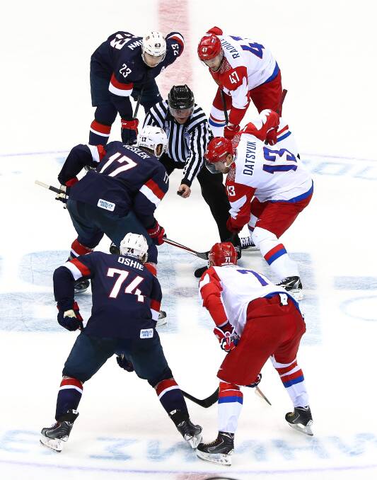 Pavel Datsyuk #13 of Russia and Ryan Kesler #17 of the United States face off during the Men's Ice Hockey Preliminary Round Group A game on day eight of the Sochi 2014 Winter Olympics at Bolshoy Ice Dome.
 (Photo by Clive Mason/Getty Images)