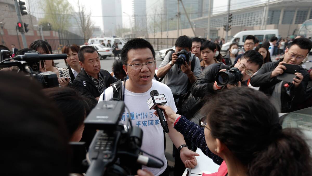 A relative of a passenger onboard Malaysia Airlines flight MH370 answers media questions at the Lido Hotel outside the Malaysia embassy on March 25, 2014 in Beijing, China. Picture: Getty