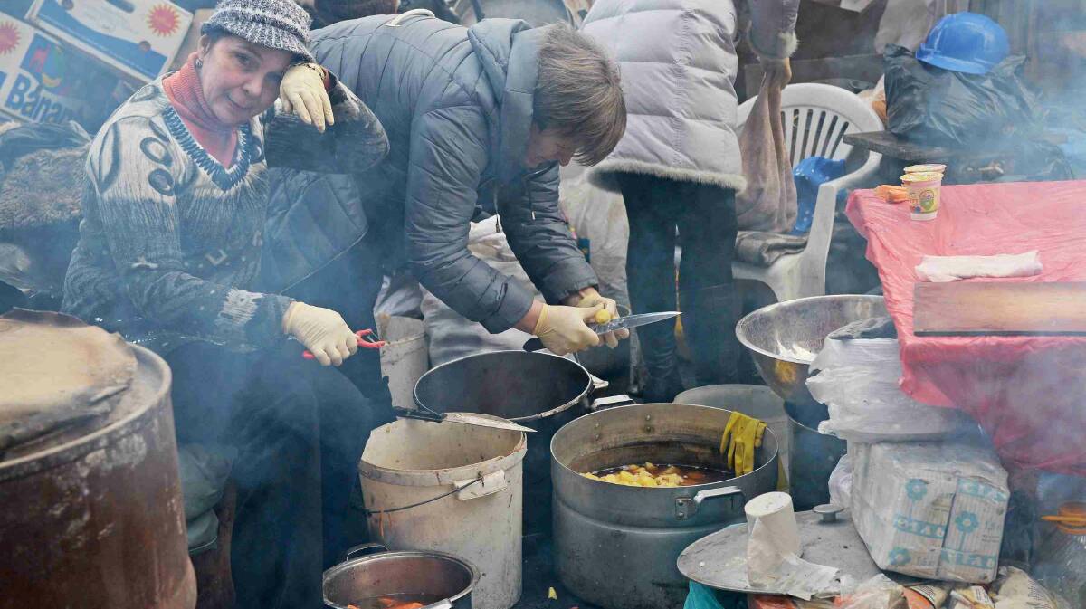 Women prepare meals for Anti- Government demonstrators as they continue to occupy Independence Square in Kiev. Picture: Getty Images