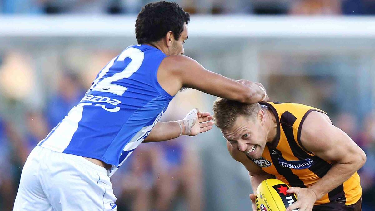Lindsay Thomas of the Kangaroos tackles Sam Mitchell of the Hawks during the round two AFL NAB Challenge match between the Hawthorn Hawks and the North Melbourne. Picture: Getty Images