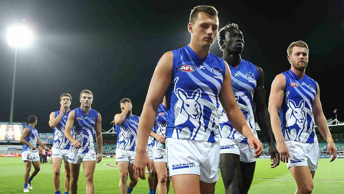 Ben Ross, Majak Daw and Lachlan Hansen of the Kangaroos players walk off after their defeat in the round two AFL NAB Challenge match between the Hawthorn Hawks and the North Melbourne Kangaroos at Aurora Stadium. Picture: Getty Images
