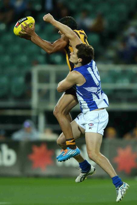 Cyril Rioli of the Hawks marks the ball against Scott Thompson of the Roos during the round two AFL NAB Challenge match between the Hawthorn Hawks and the North Melbourne Kangaroos at Aurora Stadium. Picture: Getty Images