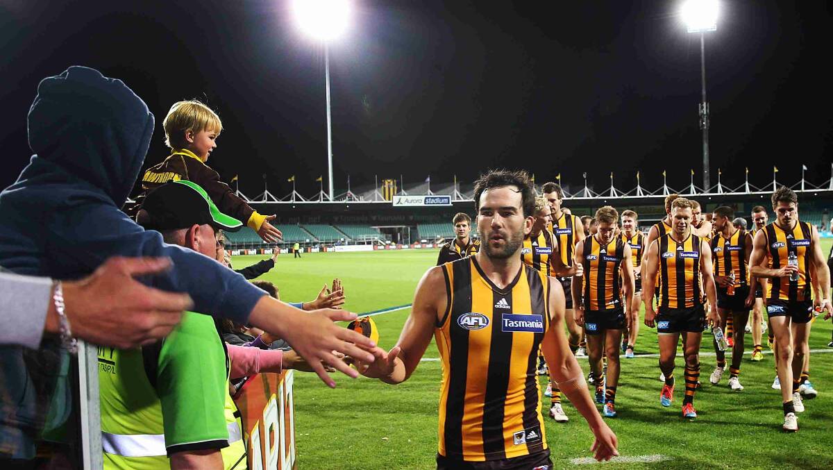 Jordan Lewis of the Hawks celebrates the win with fans during the round two AFL NAB Challenge match between the Hawthorn Hawks and the North Melbourne Kangaroos at Aurora Stadium. Picture: Getty Images