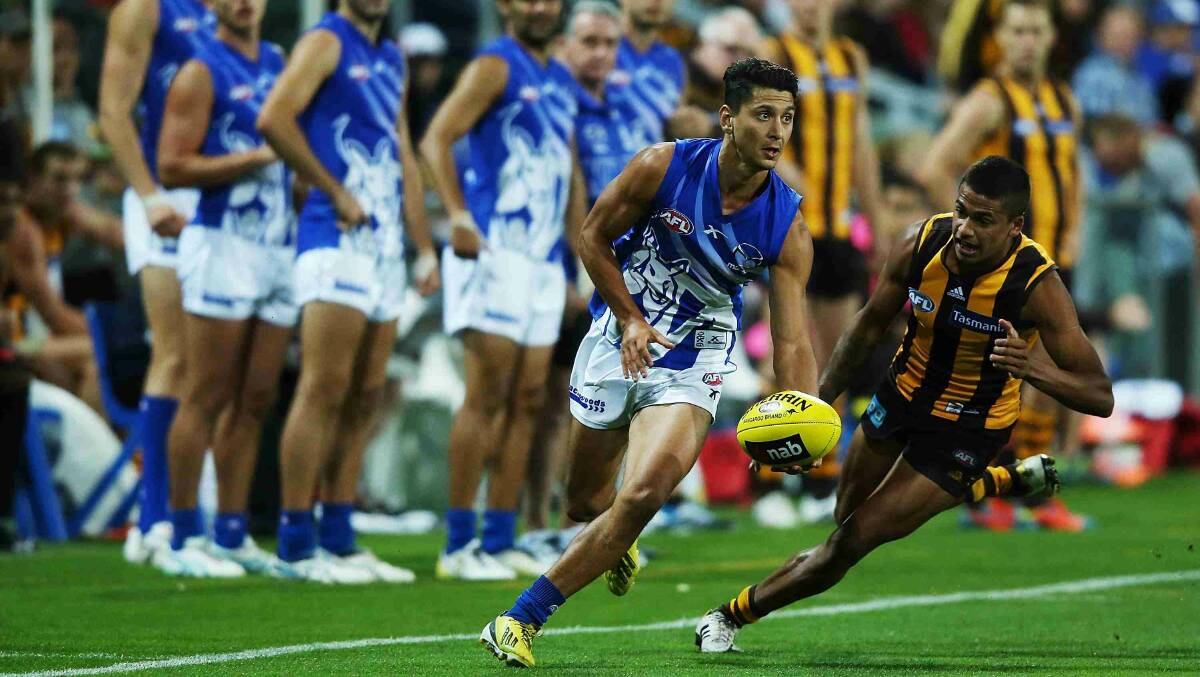 Robin Nahas of the Kangaroos runs with the ball away from Bradley Hill of the Hawks during the round two AFL NAB Challenge match between the Hawthorn Hawks and the North Melbourne Kangaroos at Aurora Stadium. Picture: Getty Images