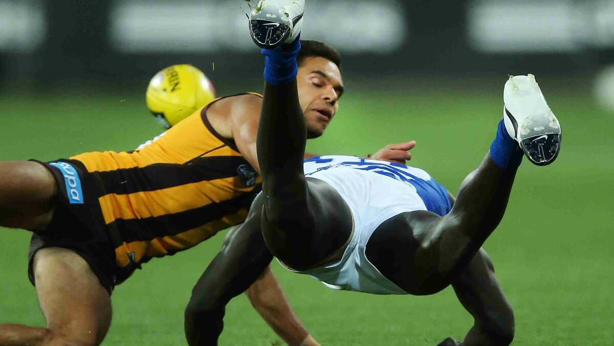 Majak Daw of the Kangaroos is tackled by Derek Wanganeen of the Hawks during the round two AFL NAB Challenge match between the Hawthorn Hawks and the North Melbourne. Picture: Getty Images