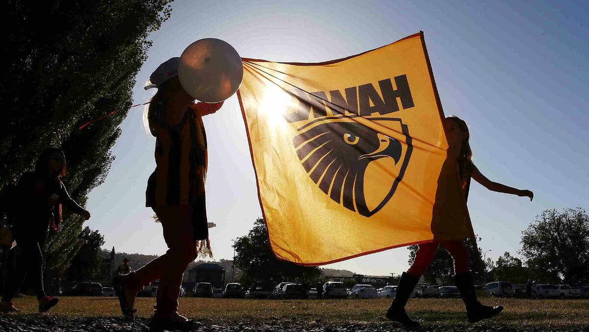 Hawks fans walk to the round two AFL NAB Challenge match between the Hawthorn Hawks and the North Melbourne Kangaroos at Aurora Stadium. Picture: Getty Images