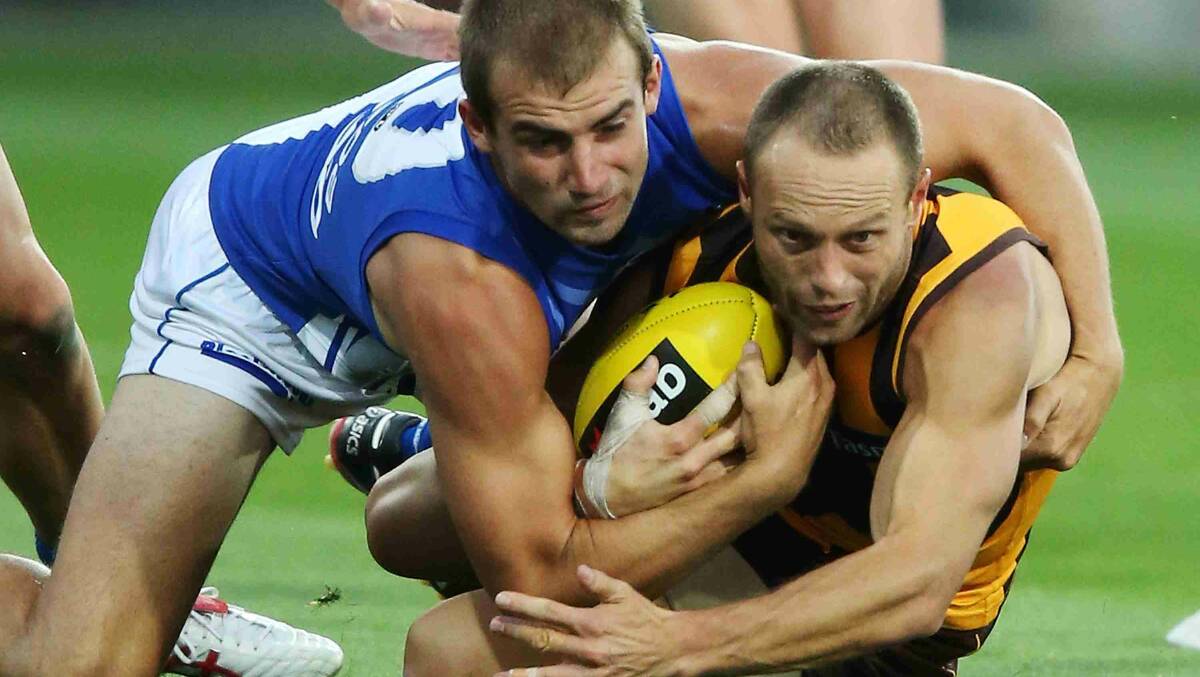  Ben Cunnington of the Kangaroos tackles Brad Sewell of the Hawks during the round two AFL NAB Challenge match between the Hawthorn Hawks and the North Melbourne Kangaroos. Picture: Getty Images