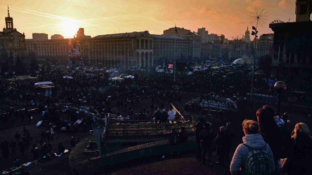 People gather as the sun sets over Independence Square in Kiev. Picture: Getty Images