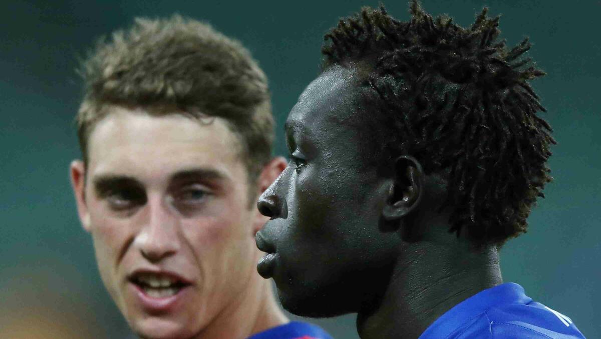 Majak Daw (R) of the Kangaroos walks off with Cameron Delaney during the round two AFL NAB Challenge match between the Hawthorn Hawks and the North Melbourne Kangaroos at Aurora Stadium. Picture: Getty Images
