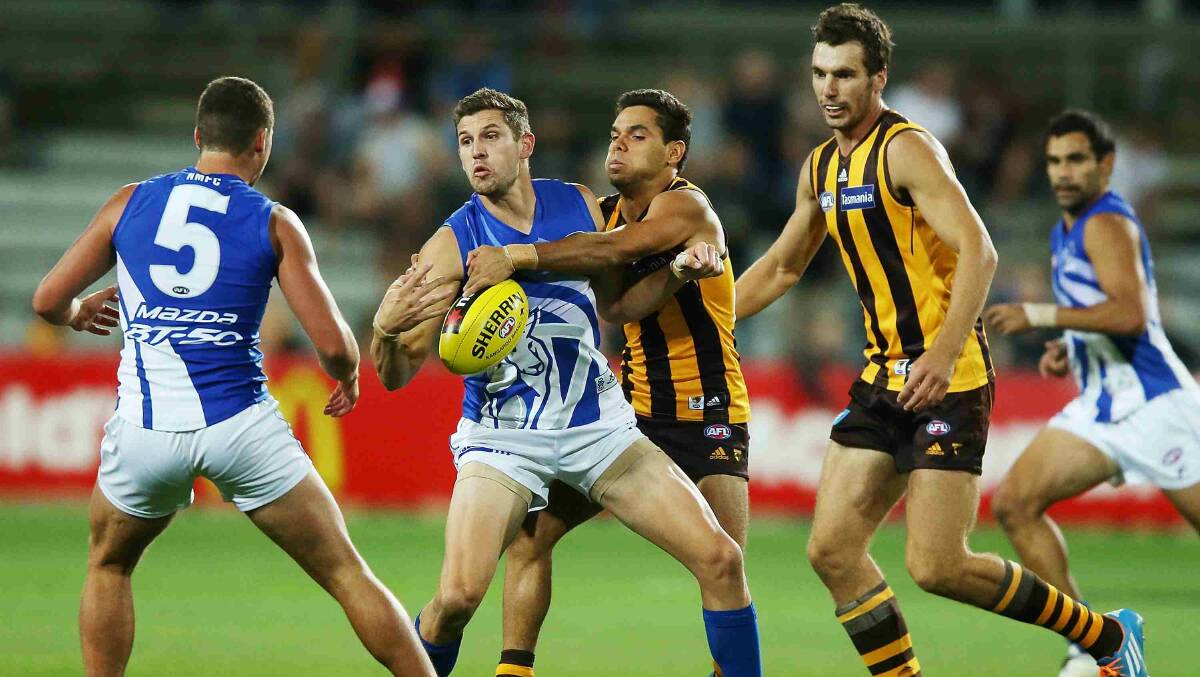 Aaron Black of the Kangaroos is tackled by Derek Wanganeen of the Hawks during the round two AFL NAB Challenge match between the Hawthorn Hawks and the North Melbourne Kangaroos at Aurora Stadium. Picture: Getty Images