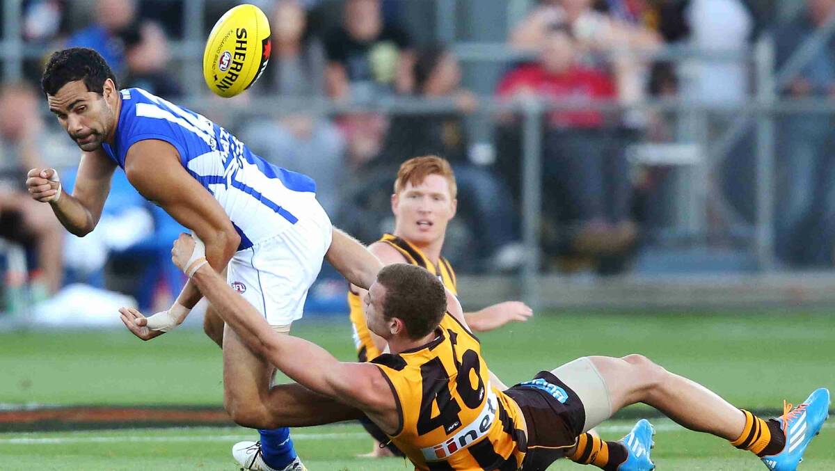 Kurt Heatherley of the Hawks tackles Lindsay Thomas of the Kangaroos during the round two AFL NAB Challenge match between the Hawthorn Hawks and the North Melbourne Kangaroos at Aurora Stadium. Picture: Getty Images