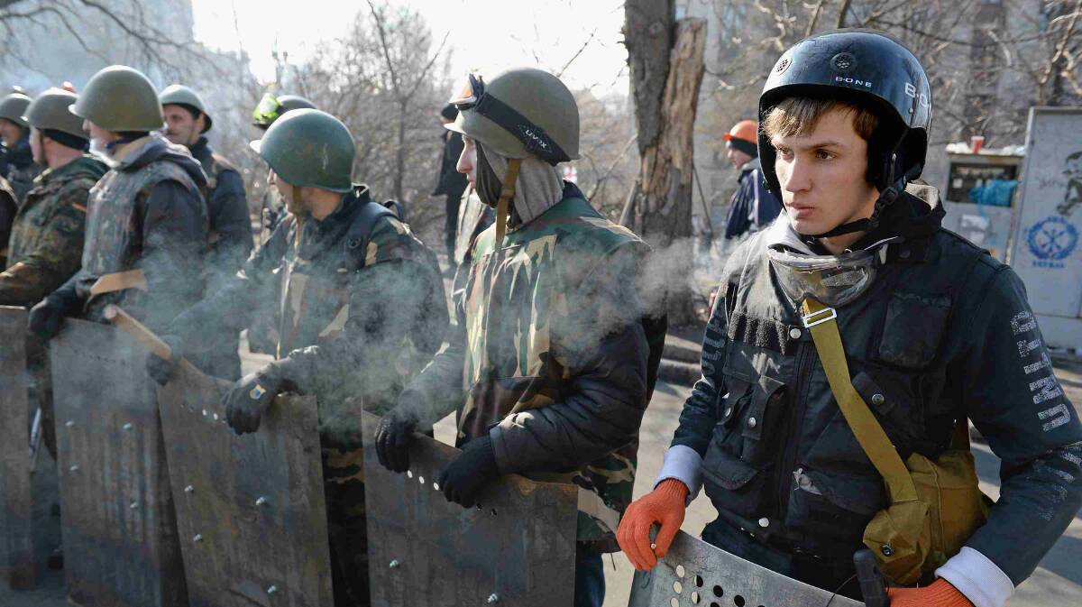 Anti-government protesters man the front line barricades following clashes with police in Independence Square in Kiev. Picture: Getty Images