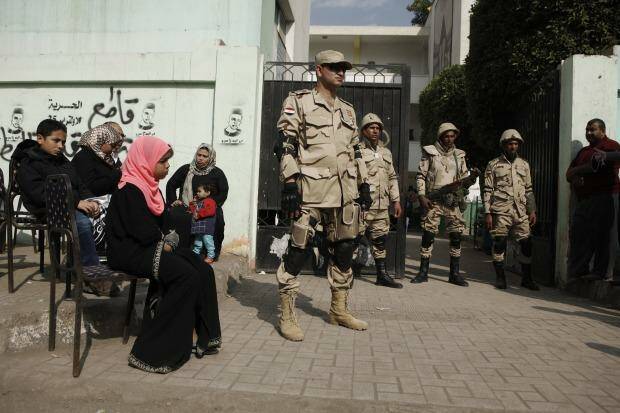 Egyptian army officers stand guard at a polling booth in the district of Imbaba. Photo: Ed Giles/Getty Images