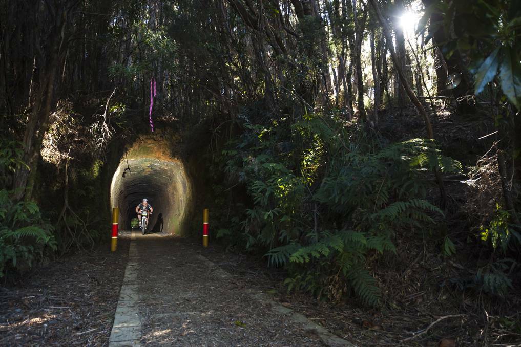 A rider races through the Spray Tunnel at Zeehan in the Pure Tasmania Wildside MTB 2014. Pic: The Advocate.
