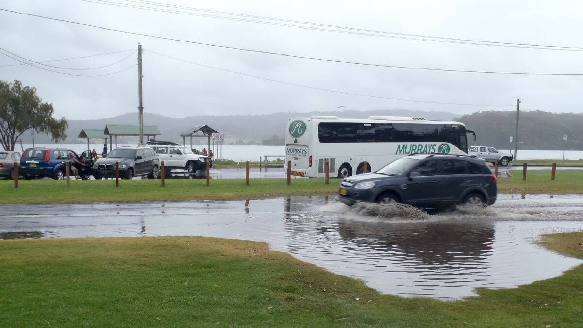 NAROOMA: “Tide Watcher” Greg Watts   snapped a few shots of the 2-metre   king tide that swamped parts of low-  lying Narooma on Thursday. The big   tide caused stormwater to back up,   inundating the road near Quota Park.